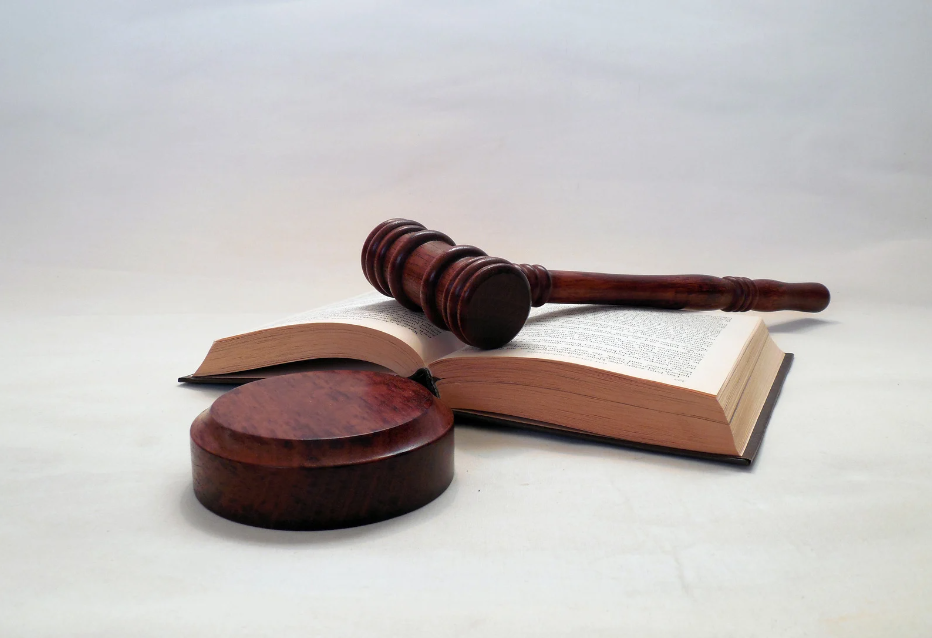 Image of a gavel resting on an open book, symbolizing the legal framework and regulations governing vaping and e-liquid products in the UK.